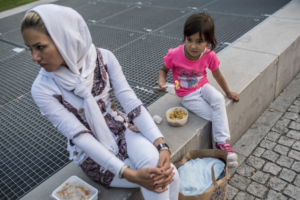 Having fled their home in Afghanistan, a mother and her daughter eat the food prepared by local volunteers in the centre of Budapest.