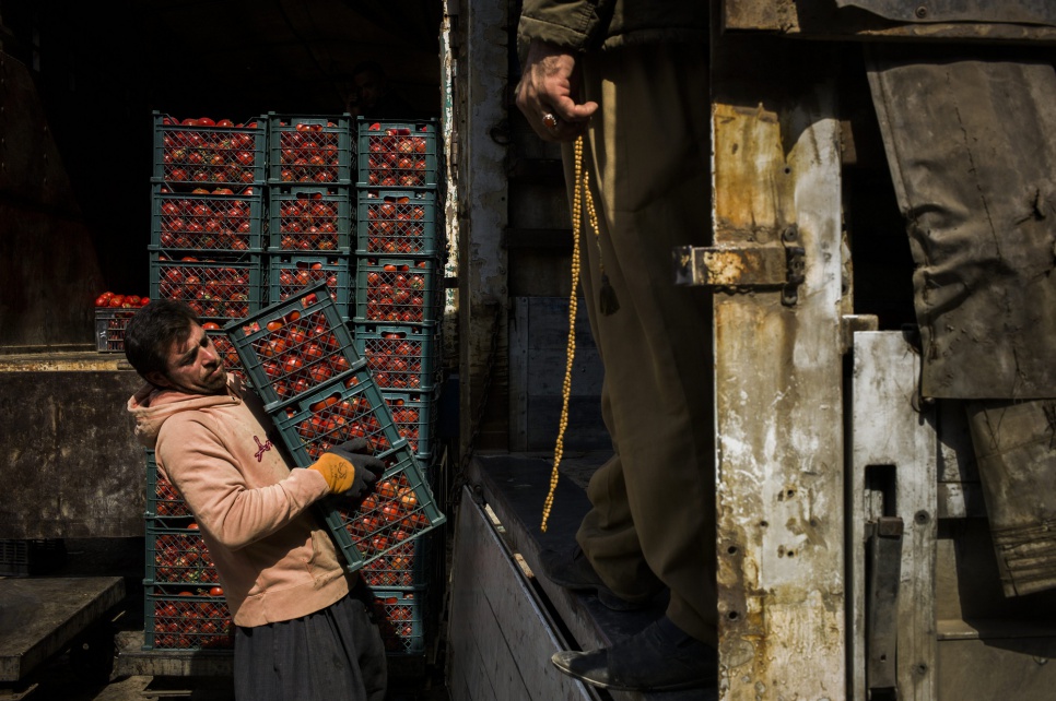 Ronak, 29, began working at Sulaymaniyah's vegetable market a year ago, after fleeing his home in Qamishli, Syria. "Thank God the work is good here," he says.