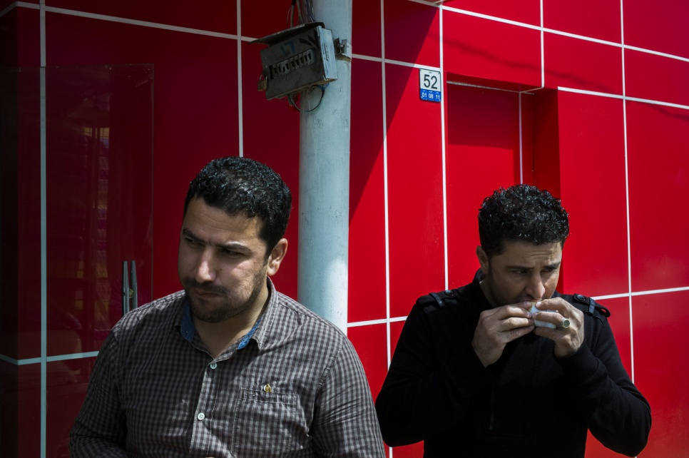 Hawre (left) and a colleague tuck into chicken sandwiches prepared by Syrian cooks in Sulaymaniyah. Fanatic about Syrian cuisine, the two Iraqis come here four times a week.