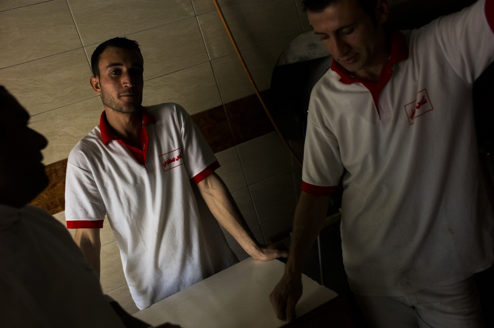 Nusheen, a refugee from Syria, has worked in this sandwich shop in Iraq's Kurdistan region for a year, earning money to support his wife and two children back at Arbat refugee camp.