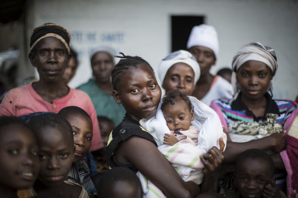 A woman cradles her child in Kavimvira transit centre in the Democratic Republic of the Congo's South Kivu Province. She is among hundreds of vulnerable Burundian refugees actively seeking safety there.