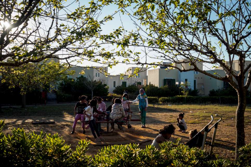 Young children play at one of the many playgrounds in LM Village, in the Peloponnese region of Greece.