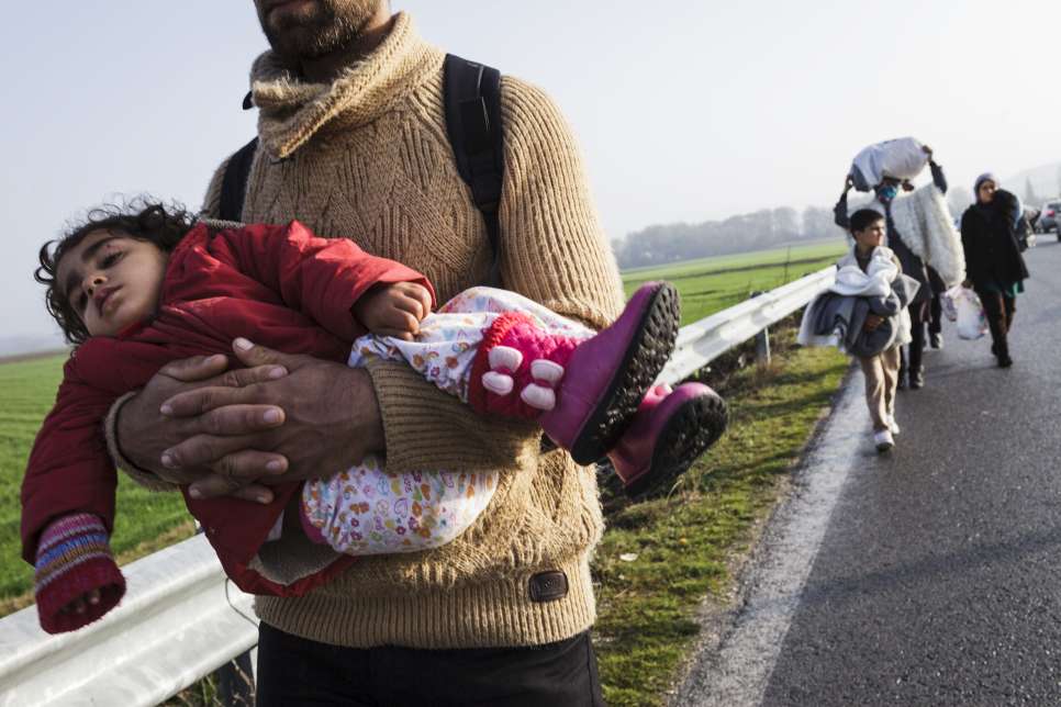 A Kurdish refugee from Aleppo, Syria, carries his young daughter while walking towards the border between Greece and the Former Yugoslav Republic of Macedonia.

Earlier this week, UNHCR, the UN Refugee Agency, warned Europe faced an imminent humanitarian crisis, largely of its own making, following a rapid build-up of people in already over-stretched Greece. "With governments not working together despite having already reached agreements in a number of areas, and country after country imposing new border restrictions, inconsistent practices are causing unnecessary suffering," UNHCR spokesperson Adrian Edwards said.

This week refugees and migrants in Greece needing assistance and accommodation soared to 30,000. Around 13,000 of these are here at Idomeni. "The crowded conditions are leading to shortages of food, shelter, water and sanitation. Tensions have been building, fuelling violence and playing into the hands of people smugglers," Edwards stressed.