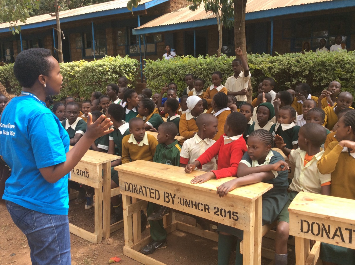 Margaret Njayakio, Associate Education Officer UNCHR interacting with the students of Murema Primary School during desk donation exercise in Ruiru