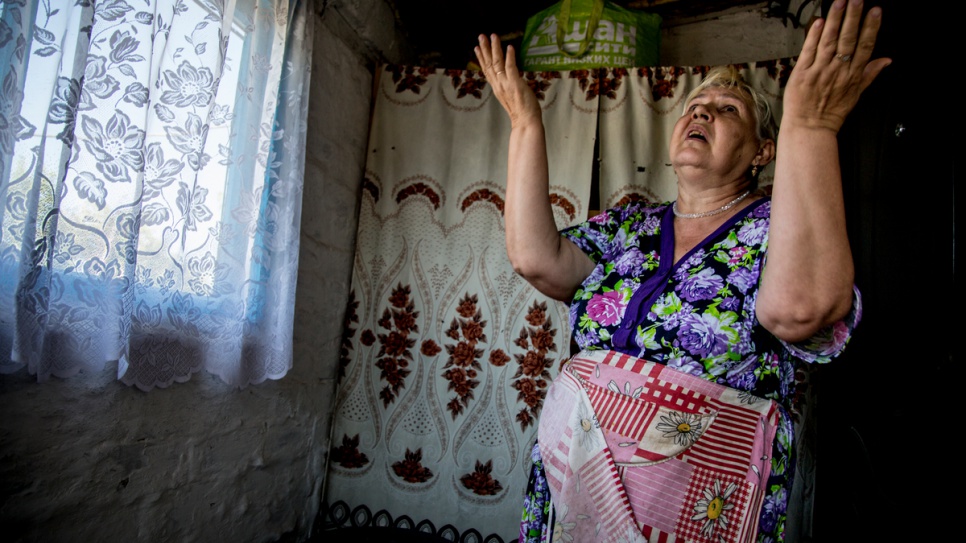 Natalia Golovchenko, 59, describes what she lived through during the 2014 conflict inside her family house in the village of Khryaschevatoye.