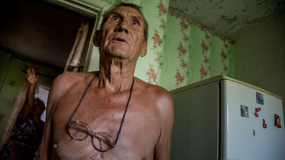 Nikolay Golovchenko, 69 and his wife Natalia Golovchenko, 59 are describing what they lived through during the 2014 conflict in their house in the village of Khryaschevatoye