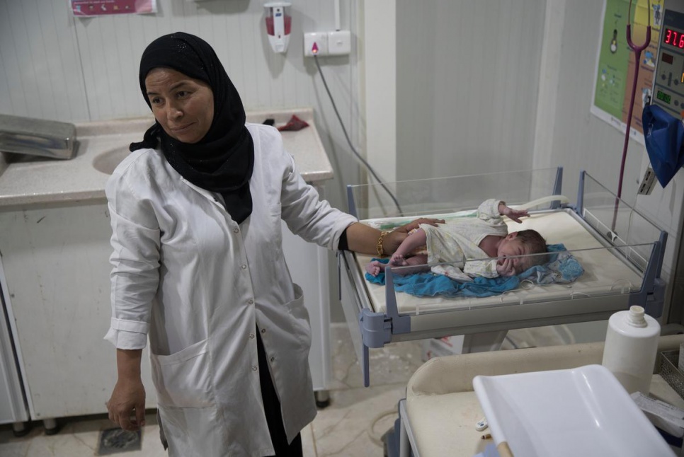 Joza, who has five brothers and sisters, is tended to by nurses at a maternity clinic at Domiz refugee camp.