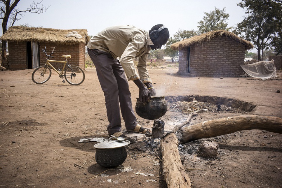 Ahmat, 16, prepares a lunch of sorghum pasta for the group of 12 boys in Dosseye camp. The boys formed teams of three and take turns to do the chores.