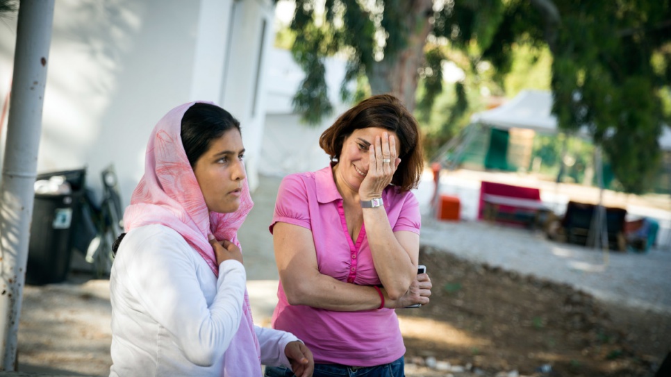 Efi Latsoudi speaks with 14-year-old Sahad from Afghanistan at PIKPA camp.