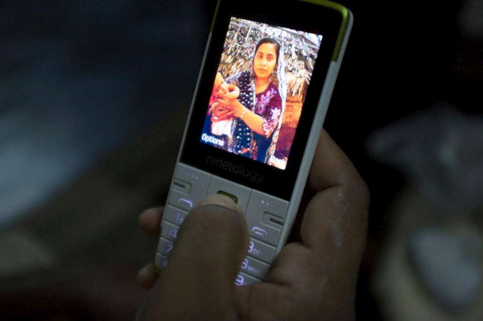 Abdul Rashid shows a photo of his wife and son taken at their home in Maungdaw, Myanmar, before they boarded a smugglers' boat in March 2015.