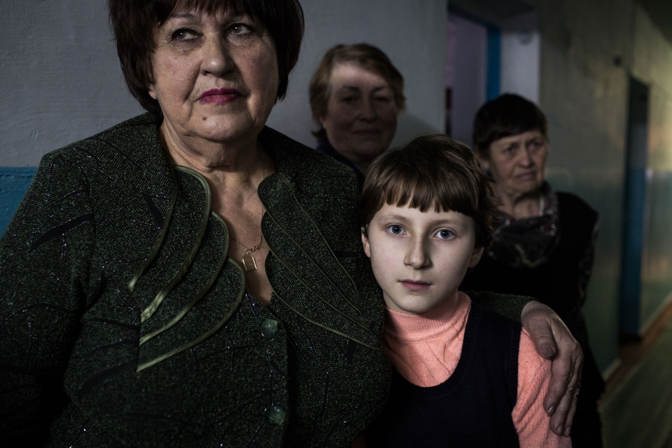 Nastya, 11, has not been to school in five months but gets private lessons each evening from Ludmila, 69, at a collective shelter in Shakhtarsk, Ukraine. "At first I was really frightened but with time I got used to the bombs and the shooting," says Nastya. "I didn't cry."