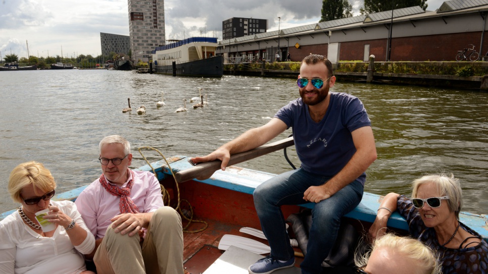 Mohammed Al Masri, 24, gives a guided tour of Amsterdam's canal network. A refugee from Syria, he crossed to Greece from Turkey in a small boat.