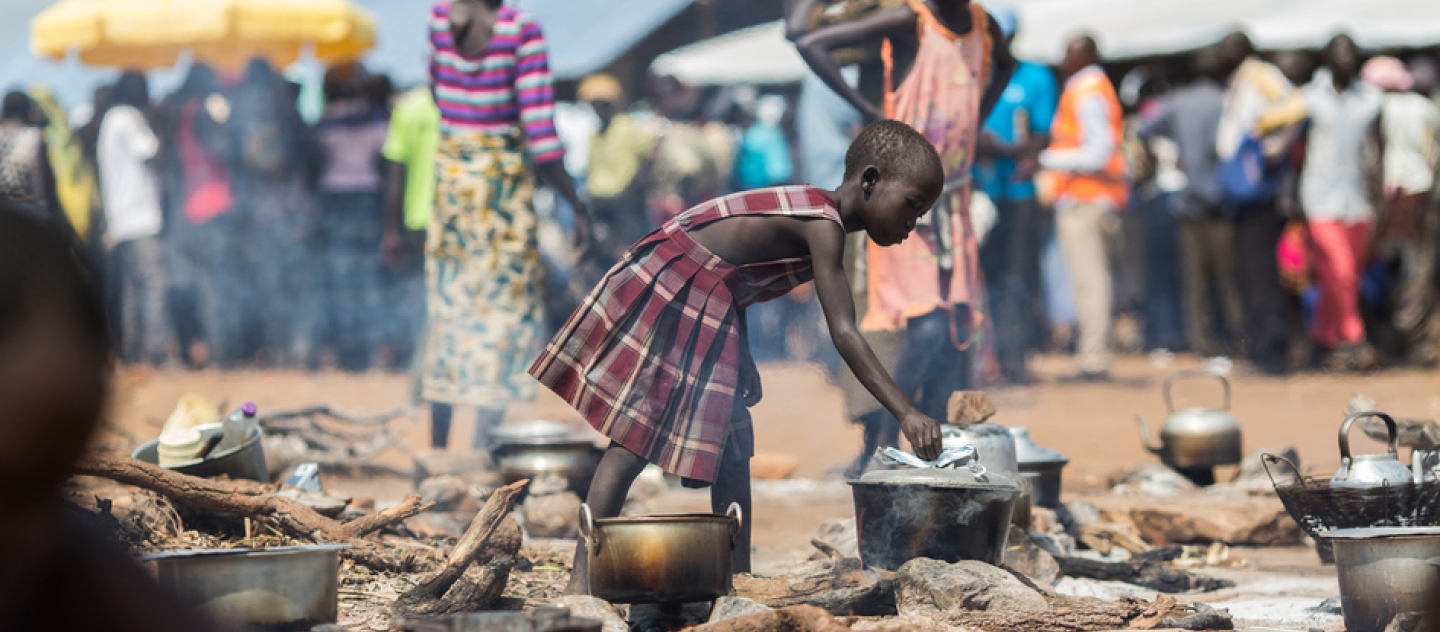 A young refugee from South Sudan cooks food at the reception centre in the newly established Pagarinya 2 camp in Adjumani District, in northern Uganda.  © UNHCR/Will Swanson