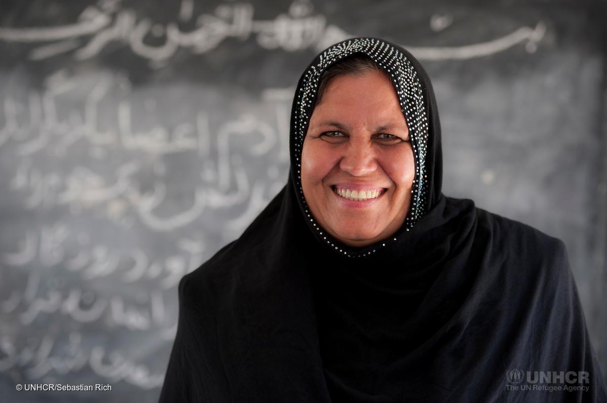 Aqeela Asifi is the 2015 winner of UNHCRs Nansen Refugee Award, recognised for her indefatigable efforts to help refugee girls access education. She has changed the lives of hundreds of young refugees. ; Aqeela Asifi, an Afghan refugee living in Pakistan, has been named the 2015 winner of UNHCRs Nansen Refugee Award.  Asifi has dedicated her adult life to educating refugee girls.  Despite minimal resources and significant cultural challenges, hundreds of girls have now passed through her school, equipped with life-long skills and brighter hopes for their futures.
 
Asifi fled from Kabul in 1992 with her young family.  They found refuge in the desolate Kot Chandana refugee village in the south-eastern Punjab province of Pakistan. Adjusting from life in a capital city and working as a teacher, to living in a dusty refugee village was difficult. She was especially struck by the total absence of schools for girls.
 
It took time but eventually Asifi was allowed to start a small school under a tent.  Over the years the school expanded and received the hard-won backing of community elders.  Asifis dedication has helped guide more than 1,000 girls through to the eighth grade and encouraged more schools to open in the village.  Another 1,500 young people (900 girls, 650 boys) are enrolled in six schools throughout the refugee village today.