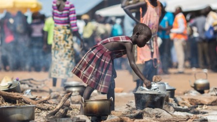 A young refugee from South Sudan cooks food at the reception centre in the newly established Pagarinya 2 camp in Adjumani District, in northern Uganda.  © UNHCR/Will Swanson