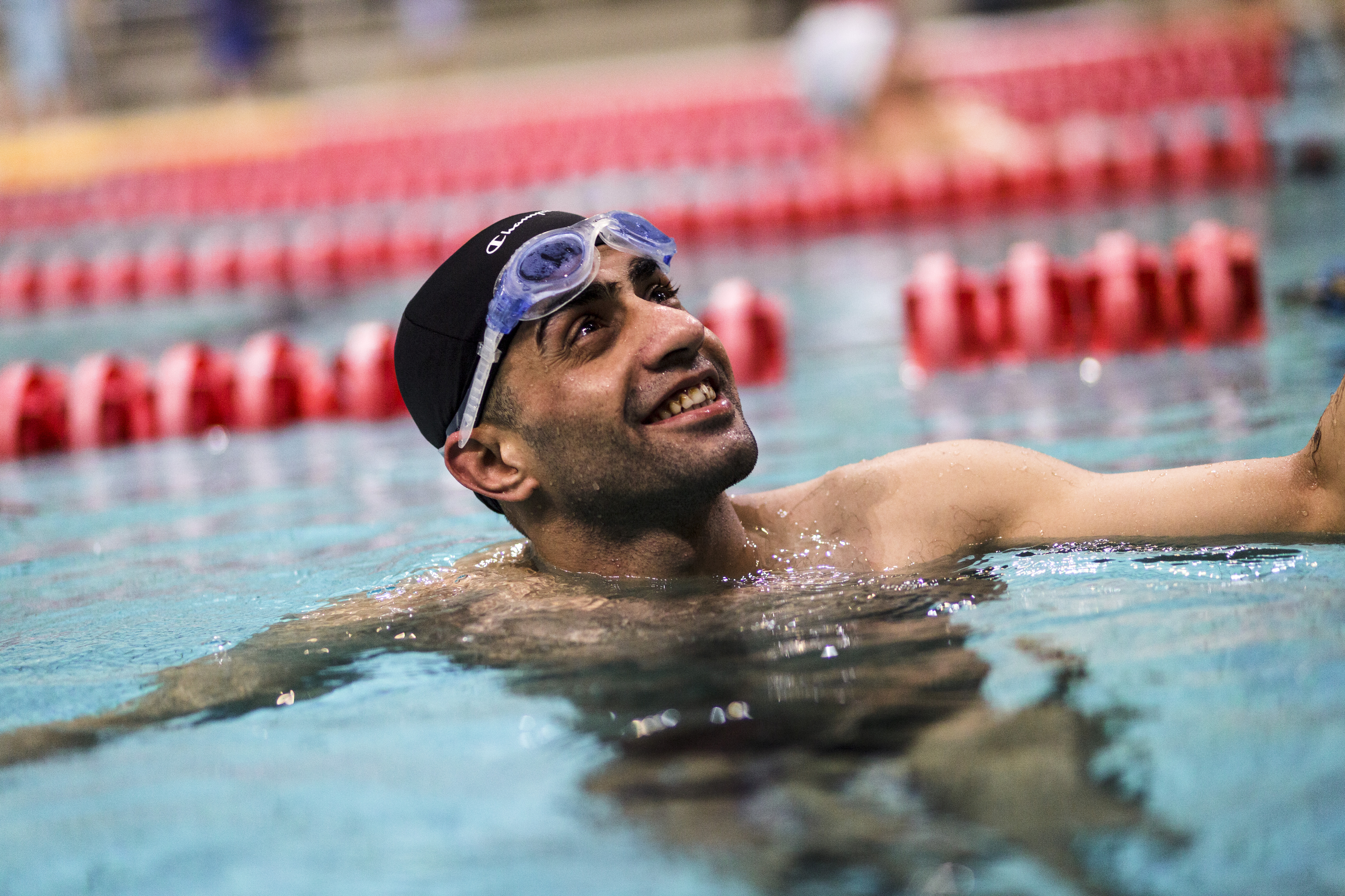 Ibrahim al-Hussein, a 27 year old refugee from Syria, during a swimming training session in the former 2004 Olympic sport complex in Athens. ; Ibrahim al-Hussein will carry the Olympic Flame in Athens as part of the torch relay for the 2016 Games in Rio de Janeiro.
The symbolic gesture is meant to show solidarity with the worlds refugees at a time when millions are fleeing war and persecution worldwide and an its an immense privilege for the a 27 year old refugee from Syria who once dreamed of competing in the Olympics and whose athletic career was interrupted by the war and an injury that cost him part of his right leg after a bombing in his home town of Deir ez-Zor.
"It is an honor," Ibrahim says of bearing the Olympic flame. "Imagine achieving one of your biggest dreams. Imagine that your dream of more than 20 years is becoming a reality."  
Ibrahim commits himself to a rigorous training schedule. Three days per week, He swims with ALMA, a Greek nonprofit organization for athletes with disabilities. His training is held in the former 2004 Olympic sport complex in Athens. He is also part of a wheelchair basketball league that meets five times per week and travels throughout the country for games. 
Ibrahim does all this despite working a 10-hour overnight shift at a cafe in Anthoupoli, an Athens suburb 30 minutes by train from his home. 
"It's not just a game for me," Ibrahim says of his commitment to athletics. "It's my life."