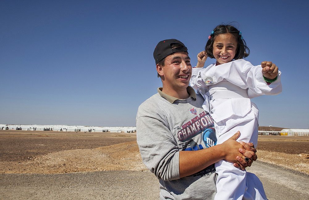 Jordan. Nine-year-old Syrian refugee, Solaf, with her brother Munaf, 21, at Azraq refugee camp