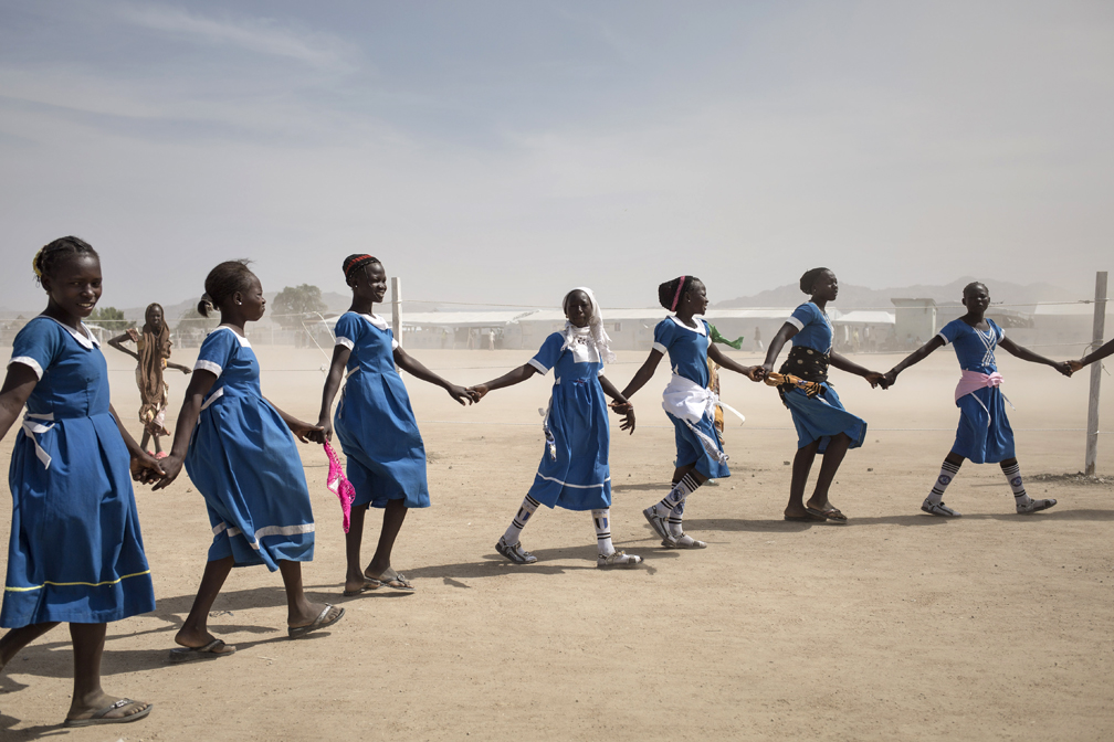 Young Nigerian refugee girls gather in Minawao camp, Cameroon,  to rehearse for a parade in honour of UNHCR High Commissioner Filippo Grandi.  © UNHCR / Alexis Huguet