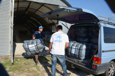 UNHCR staff Claas Morgenstern (left) and Mohamed Othman preparing thermal blankets in UNHCR warehouse in Western Greece as part of preparations for winter. There are approximately 361 tent shelters and 15 administrative buildings. In this are area of about 31,281 square meters and with the possibility of increasing in size as more refugees may be relocated here as nearby camps are reaching capacity.