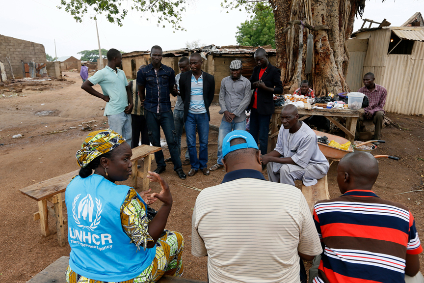 UNHCR staff talk with community members after inspecting the damages in Garaha, Adamawa state,Nigeria.  UNHCR / George Osodi