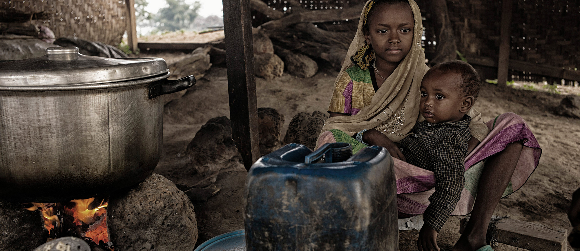 Cameroon/CAR refugees / Portrait of two unaccompanied children, brother and sister, taken on november 05, 2014, inside Adama's kitchen. Adama is a CAR refugee, cook of the Gado's refugees site and host family for orphans and unaccompagnied children. /UNHCR/O.Laban-Mattei/November 2014