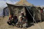 Displaced Yemeni Razaz Ali sits with four of his sons outside a tent a...