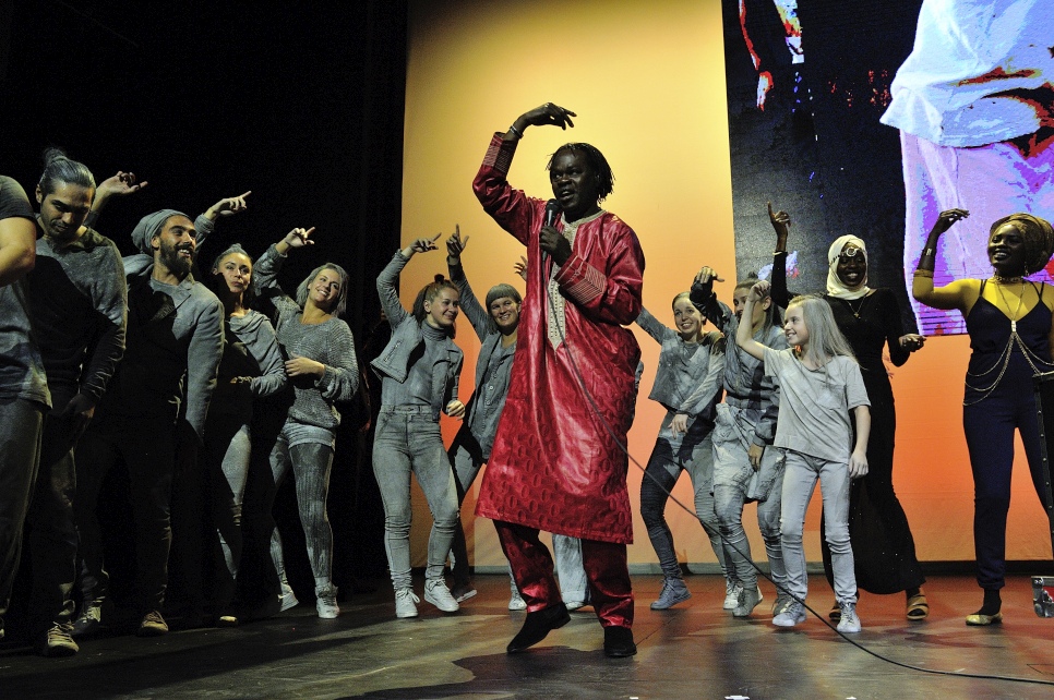 Senegalese singer and guitarist, Baaba Maal, closes the ceremony while the other performers dance in the background.