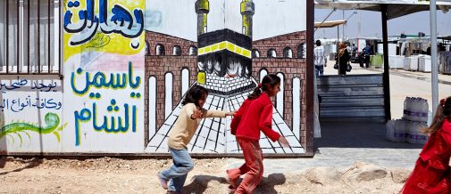 Photo of a caravan and two young refugees in Za'atari camp.