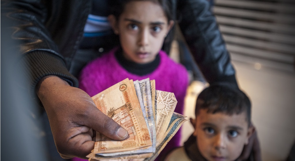 Hamidi picks up his family's UNHCR monthly cash assistance at the bank. As of May 2016, Jordan hosts more than 650,000 registered Syrian refugees, of whom the vast majority live in urban areas. UNHCR's monthly assistance programme uses fraud-proof iris-scan technology to distribute cash funds through special ATM machines, without the need for a bankcard or PIN code.