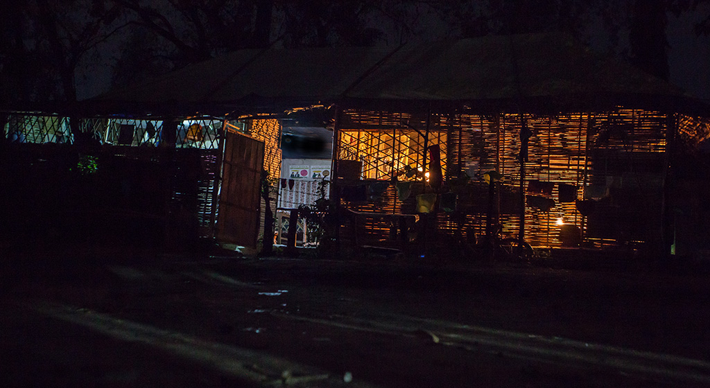 Soft light from kerosene lanterns and candles in Beldangi Refugee Camp.