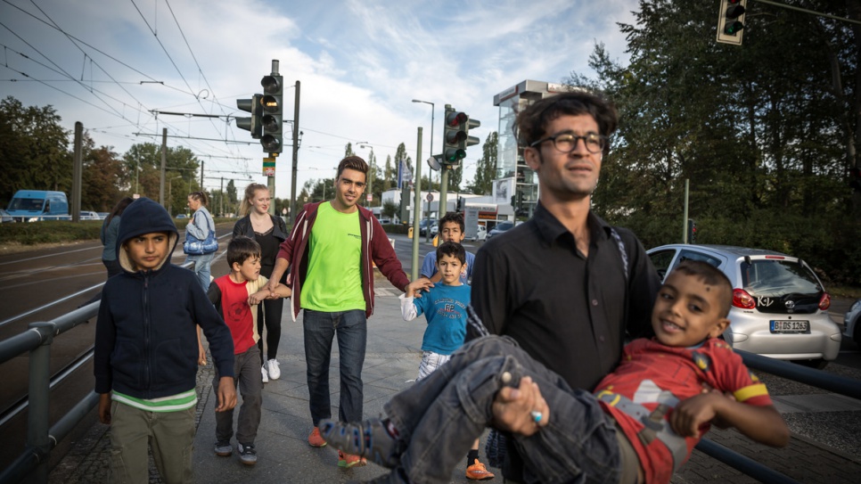 Hassan and his colleagues accompany some of the children back to their accommodation.