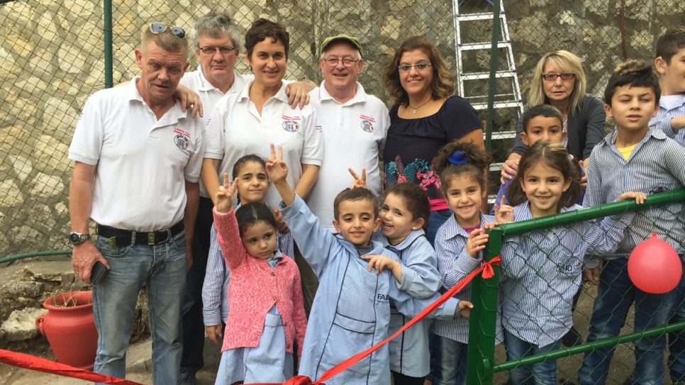 Christy Kinsella (hat), chairman of the Lebanon Trust with others on the playground of FAID.