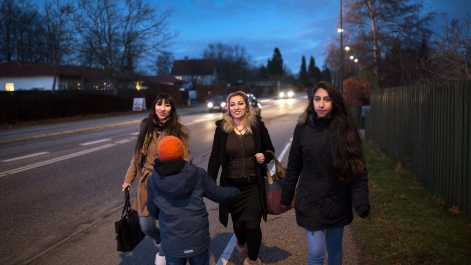 Manal and her children walk home to their flat in the suburbs of Copenhagen.