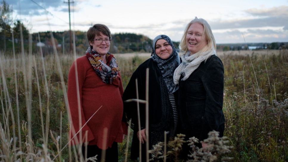 Rabiaa stands with sponsors Bronwen and Cindy in Antigonish, Canada.