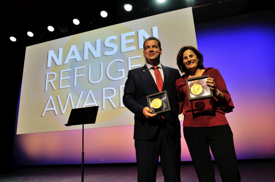 Joint winners the Hellenic Rescue Team and Efi Latsoudi of PIKPA village on Lesvos hold the humanitarian awards they received at a ceremony in Geneva.