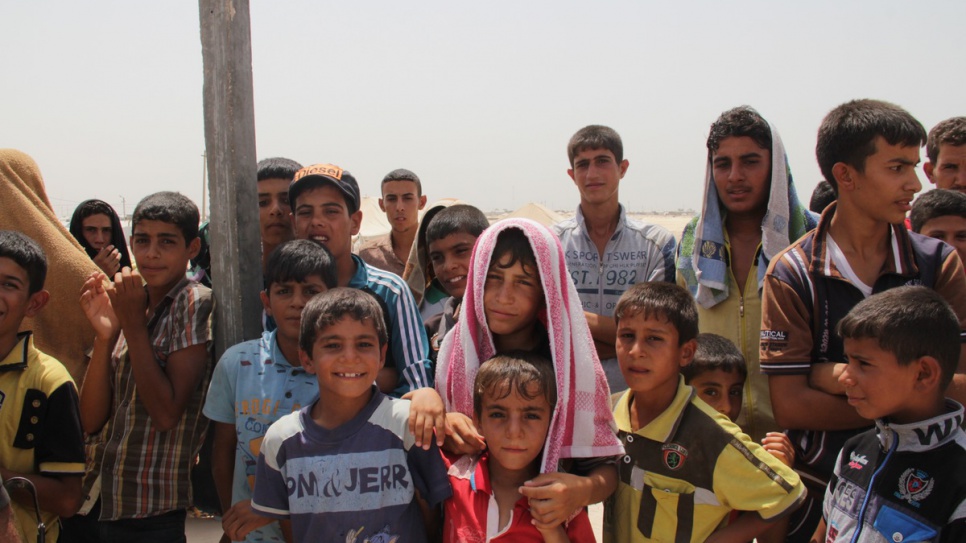 Youngsters try to stay cool with wet towels as temperatures top 50 degrees Celsius in a camp for displaced people in Habbaniyah camp.