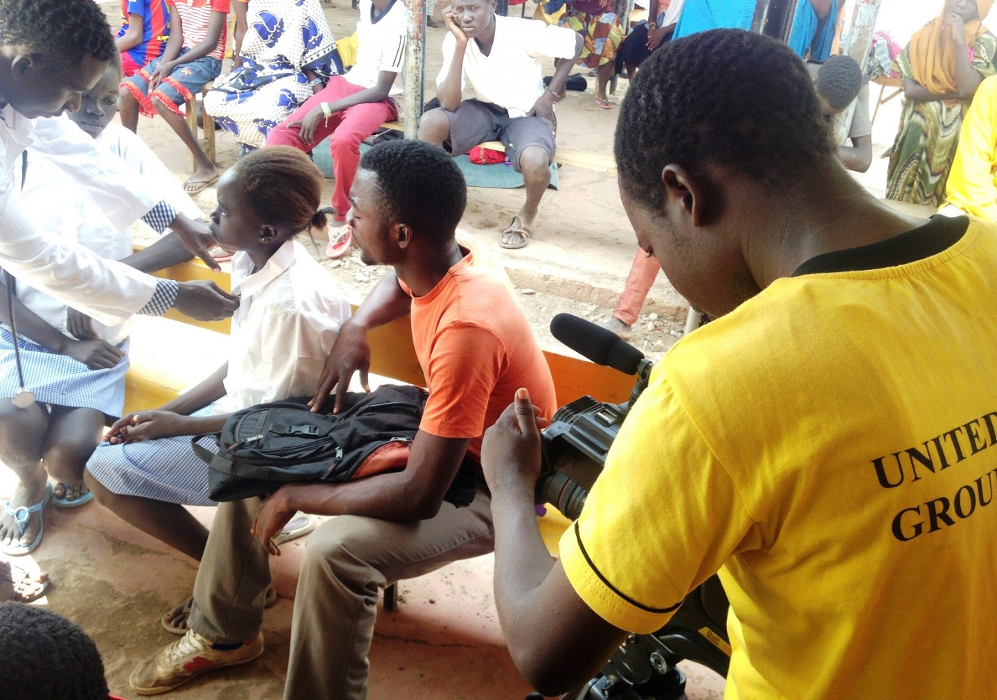 Amos (in orange shirt) with his group members on the set of the United Drama for Peace movie.