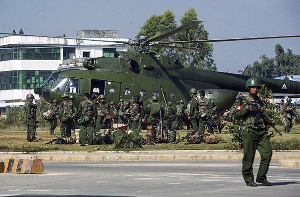 Myanmar government troops board a military helicopter in Muse township in Myanmar's northern Shan state near the border with China, Nov. 25, 2016.