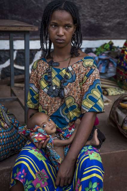 A mother mulls her situation as her wide-eyed child looks at the camera in the Batouri Hospital nutrition centre. They are safe and well on the road to recovery but the future remains uncertain. 