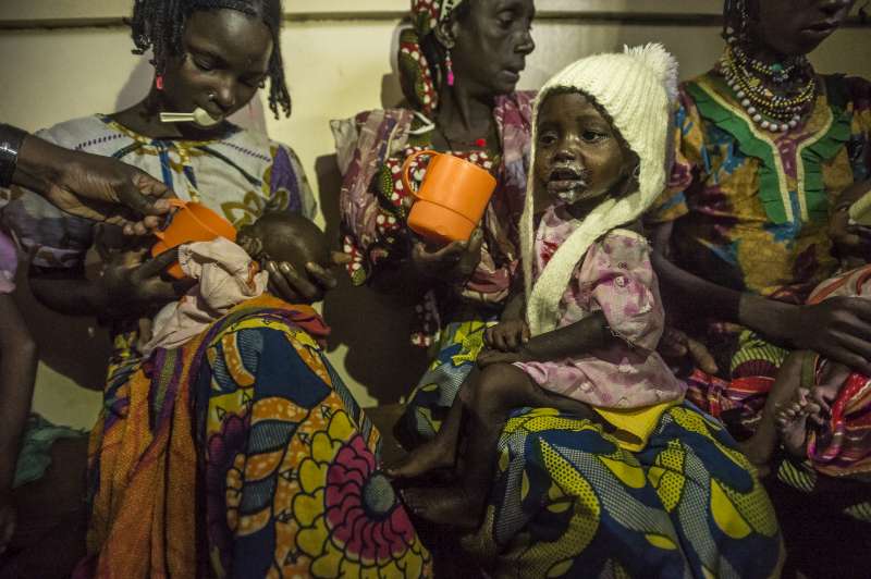 Malnourished children from Central African Republic at feeding time with their mothers in Batouri Hospital. Many children crossing the border into Cameroon are suffering from malnutrition.