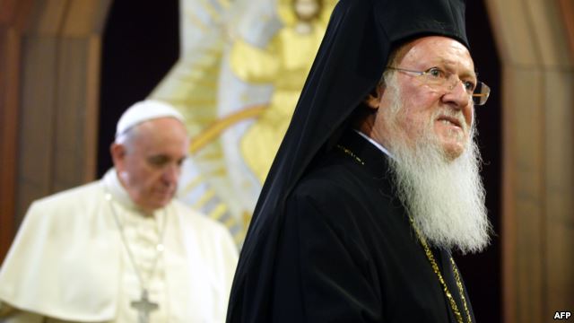 Pope Francis (left) and Ecumenical Patriarch Bartholomew I leave after they signed a joint statement at St. George church in Istanbul on November 30.