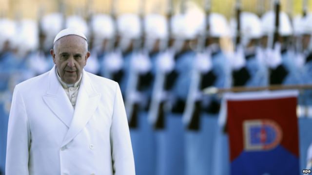 Pope Francis reviews a honor guard during a welcoming ceremony at the presidential palace in Ankara, Turkey.