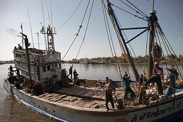 Migrants work aboard a fishing boat in Mahachai on the outskirts of Bangkok, Thailand, in this undated file photo.