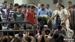 Migrants who were rescued from a boat that capsized in the Mediterranean Sea are pictured in Al-Beheira, Egypt on September 22. More than 100 people are known to have perished in the incident.