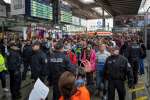 A train filled with refugees and migrants arrives in Munich's central station on platform 17. Police escorted new arrivals to an area set up for medical checks. 