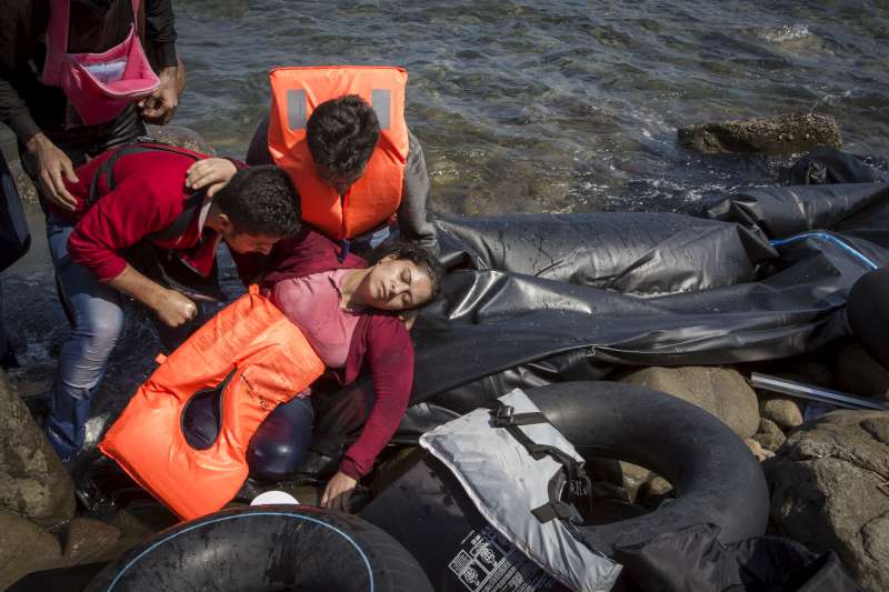 A refugee from Aleppo, Syria, collapses from seasickness and fatigue after the journey from Turkey to Lesvos. She is travelling with her husband and three children. 
