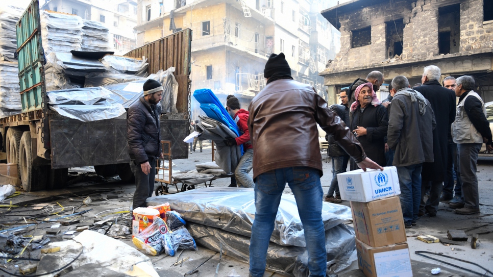 Residents of Aleppo receive crucial relief items from UNHCR and other UN partners in the Al-Sha'aar neighborhood of eastern Aleppo. 