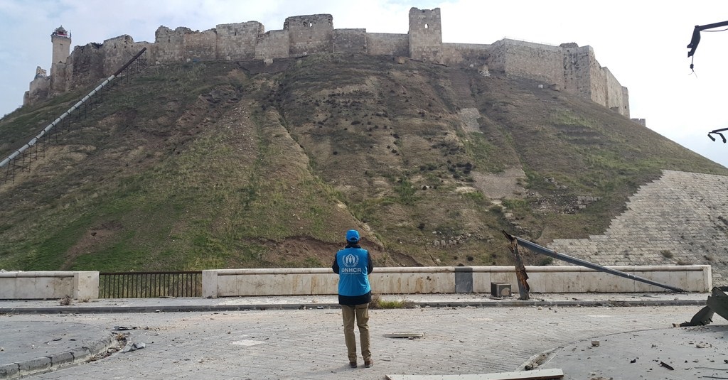 A UNHCR staff stands in front of the Citadel of Aleppo, a large medieval fortified palace in the centre of the old city of Aleppo, which considered to be one of the oldest and largest castles in the world. The Citadel has received significant damage during the battle for Aleppo since 2012. For the first time since the battle for Aleppo erupted in 2012, UNHCR, the UN Refugee Agency, has been able to enter the old city of Aleppo.  The scale of the destruction to infrastructure and historic buildings was evident. Centuries of civilization now stand in ruins after four years of intense fighting over Aleppo, once Syria’s largest city and one of the oldest continuously inhabited cities in the world.