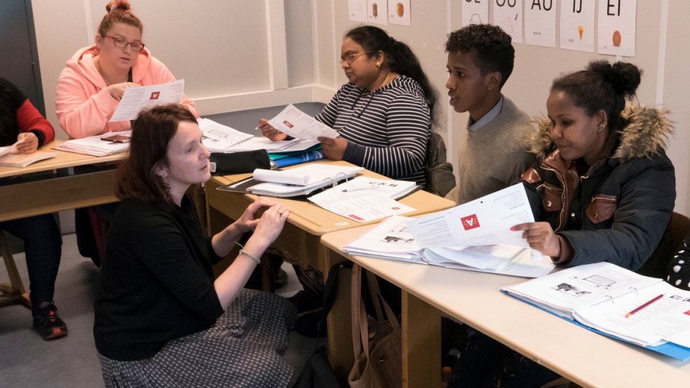 Rahel learns Dutch at language school with other refugees and migrants.