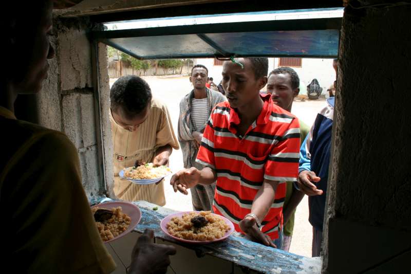 A new arrival enjoys his first meal in three days at the Mayfa'a reception centre in Southern Yemen.